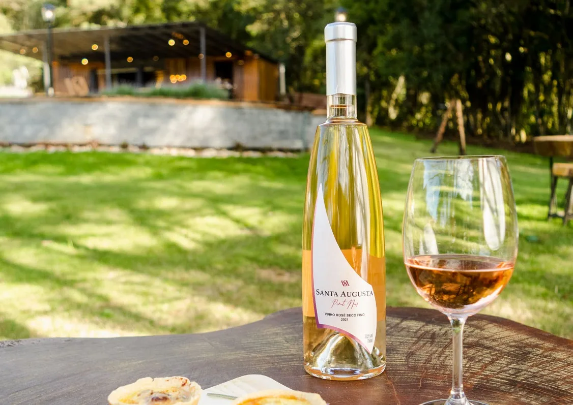 Vinho rosé e taça sobre uma mesa no Wine Garden Santa Augusta